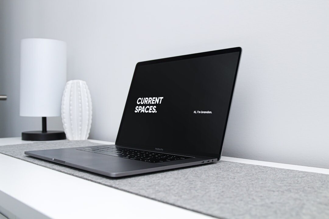 Laptop and notebook on a bright minimal workspace