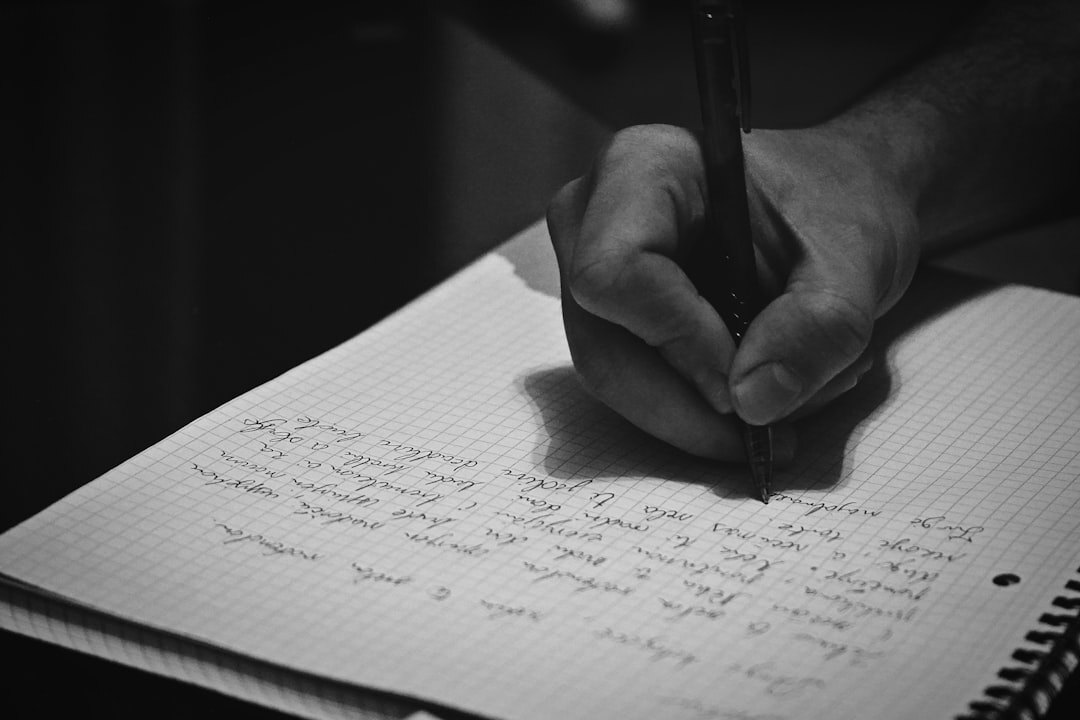 man writing notes