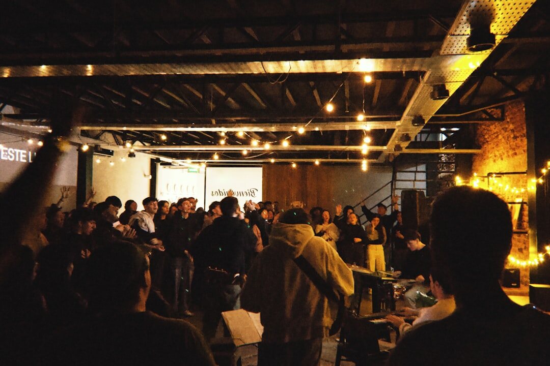 Audience listening attentively at an indoor event